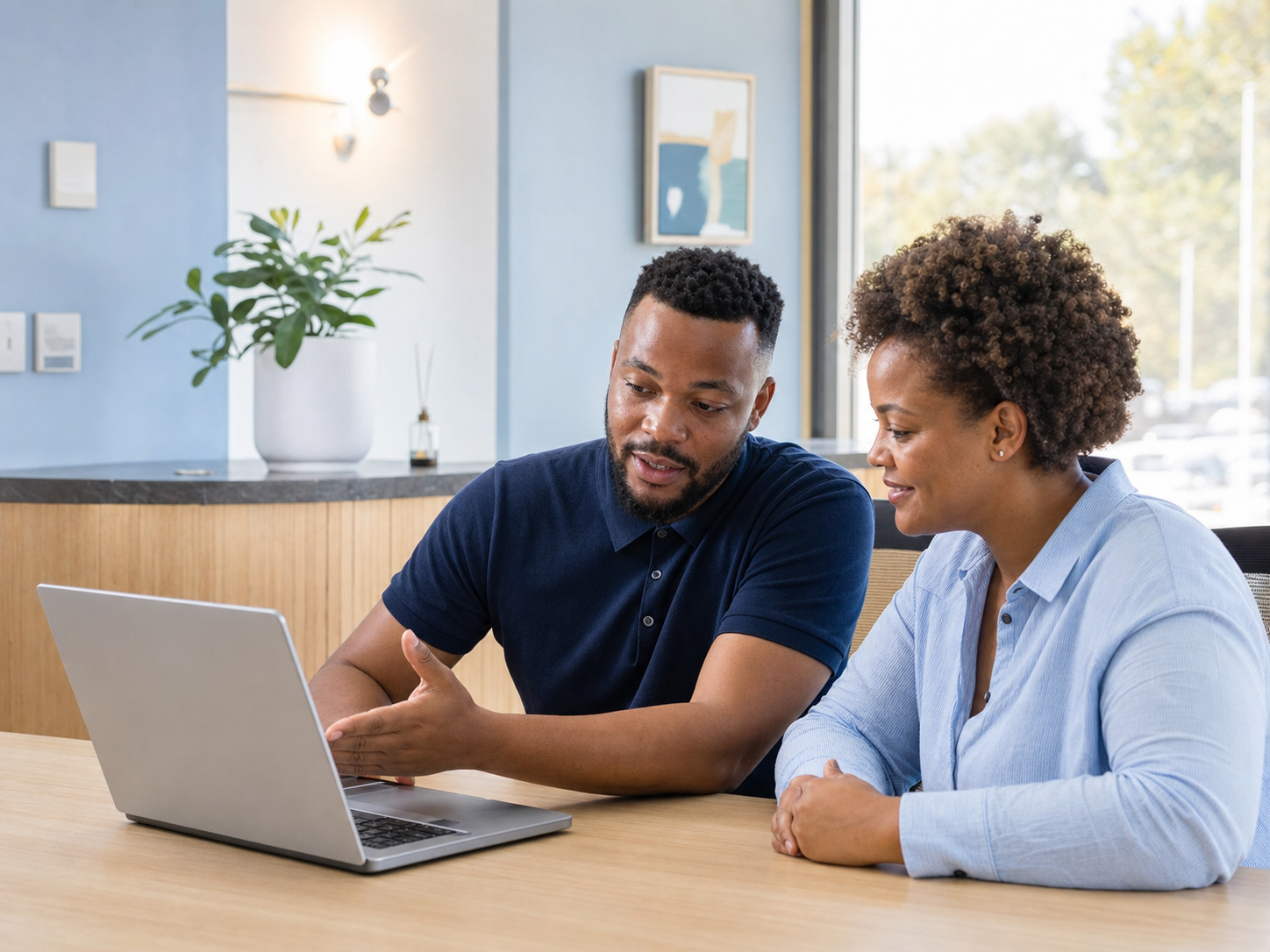 An IT specialist helping a local business owner configure software
